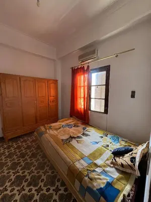 a bedroom with a large bed with a window at Appartement 135 m spacieux in Oulad Akkou
