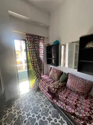 a living room with a couch and a window at Appartement 135 m spacieux in Oulad Akkou