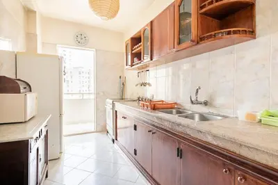 a kitchen with a sink and a refrigerator at Bel appartement in Oulad Akkou