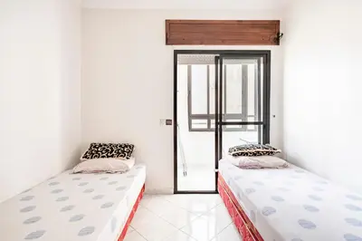 two beds sitting next to each other in a room at Bel appartement in Oulad Akkou