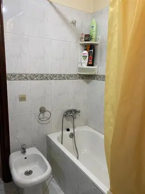 a bathroom with a toilet and a tub and a sink at Bel appartement in Oulad Akkou