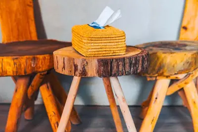 a hat sitting on top of two wooden stools at Sanmao Desert Luxury Camp in Merzouga