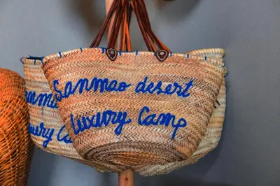 a sierra dust jimmy lane bag on a wall at Sanmao Desert Luxury Camp in Merzouga