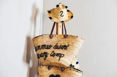 a wicker purse hanging on a wall at Sanmao Desert Luxury Camp in Merzouga