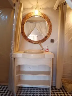 a bathroom with a sink and a mirror at hiya luxury camp in Merzouga
