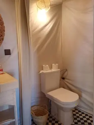 a bathroom with a white toilet and a sink at hiya luxury camp in Merzouga