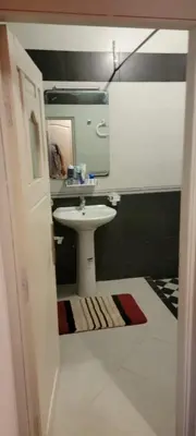 a bathroom with a sink and a mirror at طريق تمصلوحت مراكش in Oulad Akkou