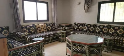 a living room with two couches and a table at طريق تمصلوحت مراكش in Oulad Akkou