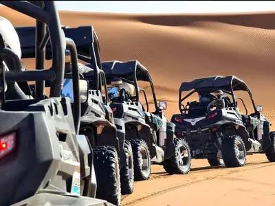 a group of four atvs in the desert at Glamping Under Stars in Merzouga