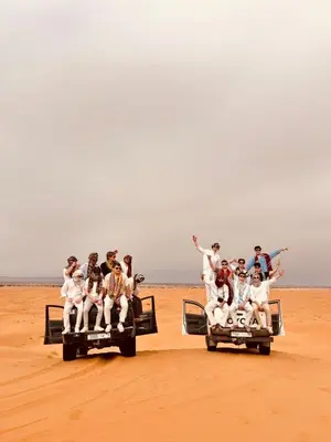 a group of people riding on the back of two jeepneys at Glamping Under Stars in Merzouga
