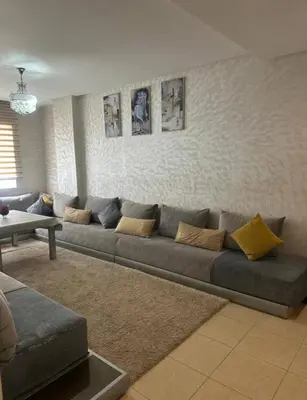 a living room with a couch and a table at Ismail in Oulad Akkou