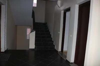 a staircase in a house with black tile floors at Appartement juste pour les familles in Ifrane