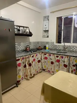 a kitchen with a refrigerator and a counter top at Appartement juste pour les familles in Ifrane