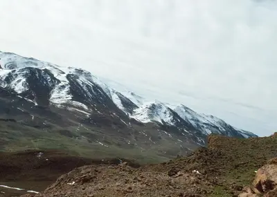 a snow covered mountain in the distance at berber discovery land