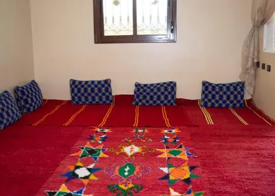 a room with a bed with a colorful rug on it at berber discovery land