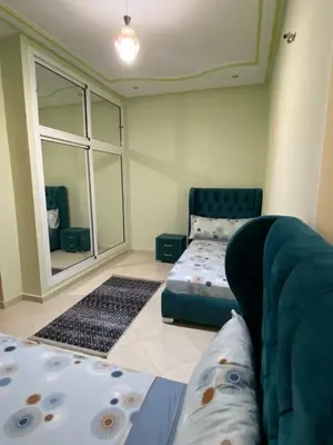 a living room with a couch and a large window at Family Apartment in City Centre in Douar Oulad Mhammed