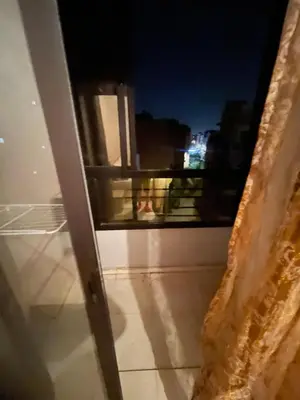 an outside view of a balcony at night at Rayhana in Oulad Akkou