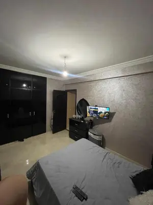 a bedroom with a bed and a flat screen tv at Rayhana in Oulad Akkou