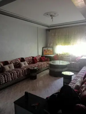 a living room with couches and a table at Kinan in Taza