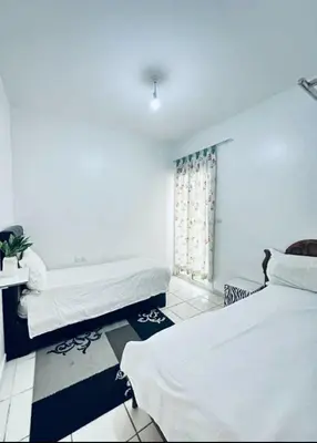 a room with two beds and a window at Marhaba in Fès