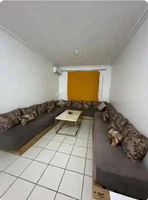 a living room with a couch and a table at Marhaba in Fès