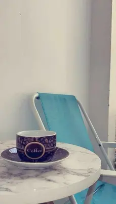 a cup on a plate on a table in a chair at Marhaba in Fès
