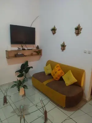a living room with a couch and a tv at Marhaba in Fès