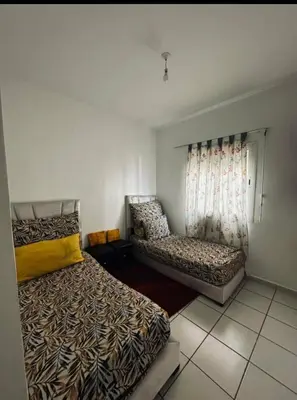 a bedroom with two beds and a couch in it at Marhaba in Fès