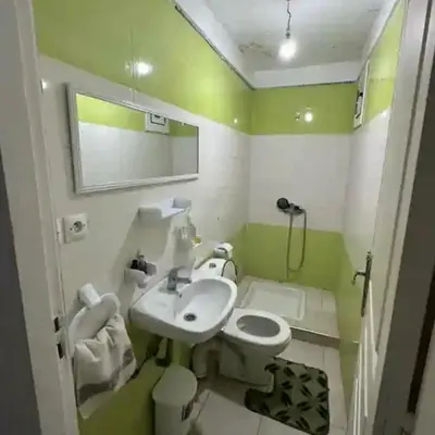 a small bathroom with a sink and a toilet at Marhaba in Fès