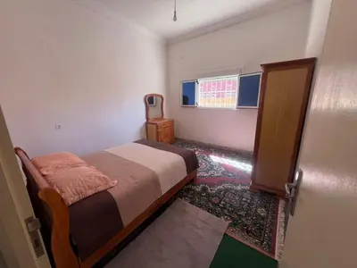 a small bedroom with a bed and a window at Halouli in Tinerhir