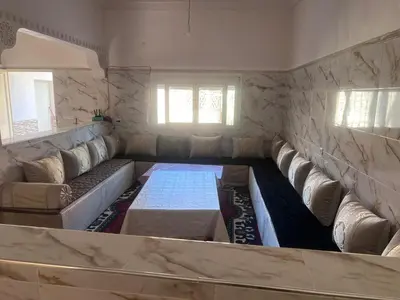a living room with a couch and a table at Halouli in Tinerhir