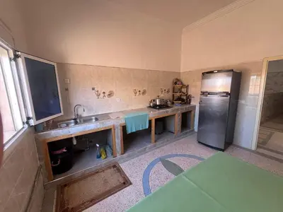 a kitchen with a sink and a refrigerator at Halouli in Tinerhir