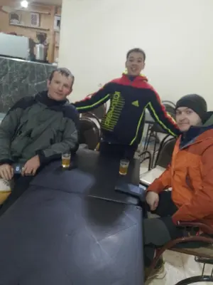 a group of three people sitting at a table at Rani hani chez ali in Tinerhir