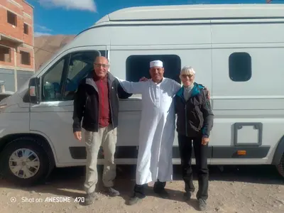 a group of three people standing in front of a van at Rani hani chez ali in Tinerhir