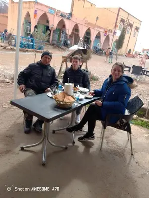 a group of people sitting at a picnic table at Rani hani chez ali in Tinerhir