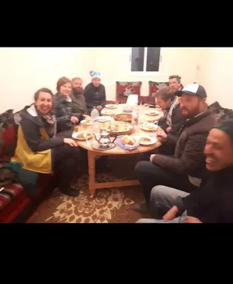 a group of people sitting around a table at Rani hani chez ali in Tinerhir