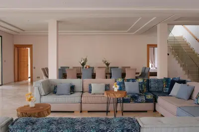 a living room with couches and a staircase at Marilah in Marrakech