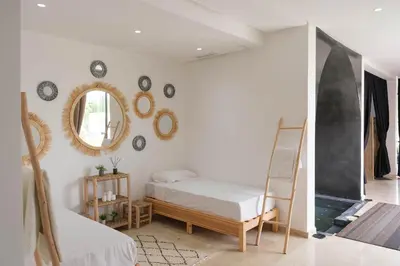 a bedroom with a bed and mirrors on the wall at Marilah in Marrakech