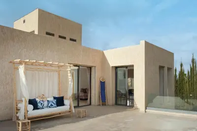 a couch on a porch in front of a building at Marilah in Marrakech