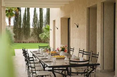 a long table with chairs and food on it at Marilah in Marrakech
