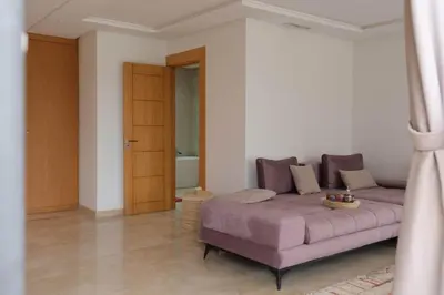 a living room with a purple couch in a room at Marilah in Marrakech