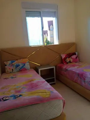 a bedroom with two beds and a window at Saloumi Appartment in Ifrane