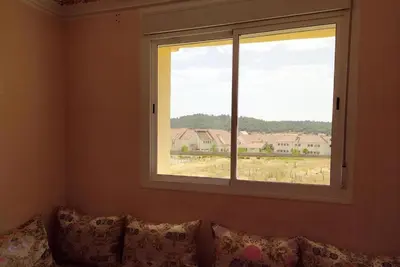 a window in a room with a couch with pillows at Saloumi Appartment in Ifrane