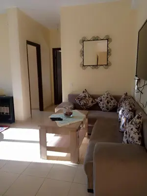a living room with a couch and a table at Saloumi Appartment in Ifrane
