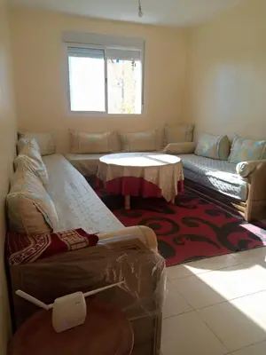 a living room with a couch and a table at Saloumi Appartment in Ifrane