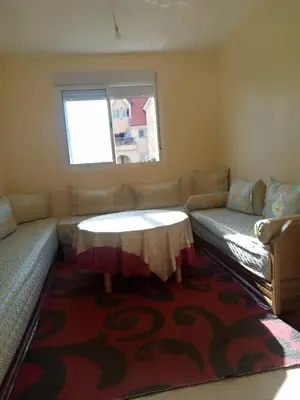 a living room with a table and a couch at Saloumi Appartment in Ifrane