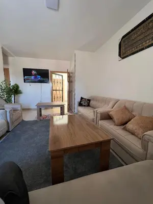 a living room with a couch and a coffee table at Smartkeys in Oulad Akkou
