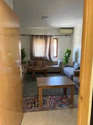 a living room with a couch and a table at Smartkeys in Oulad Akkou