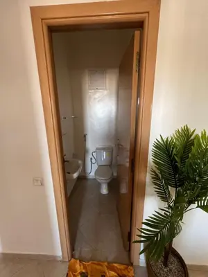 a bathroom with a toilet and a sink in it at Smartkeys in Oulad Akkou