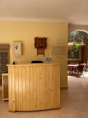 a kitchen with a wooden counter in a room at Dyafat Abla in Oulad Akkou